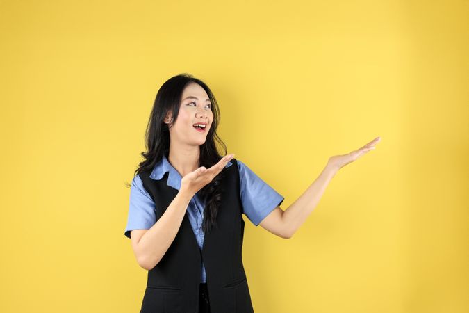 Young Asian woman Pointing Up to Copy Space and Looking up to Copy Space with Smile Face