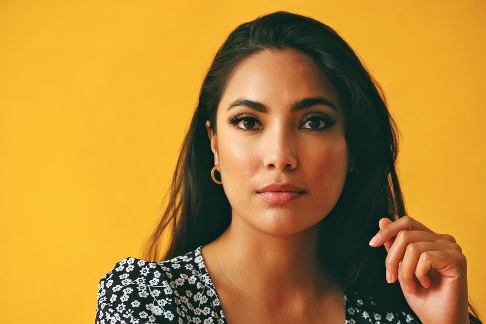 Close up of Hispanic woman wearing dress in yellow room