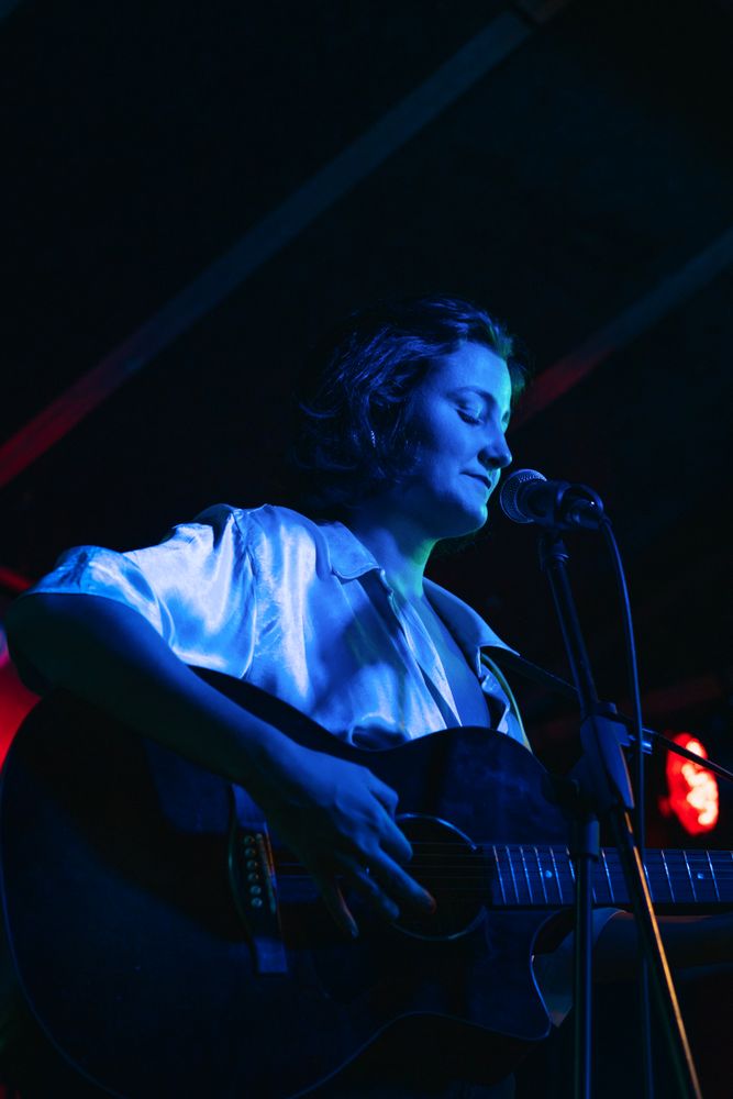 Musicians In Stage With Colorful Lights Performing In A Live Concert
