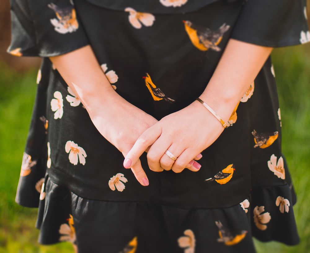 Cropped image of woman wearing dark floral dress