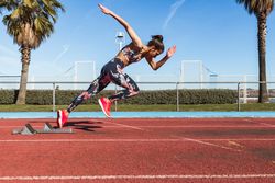 Slim woman running on stadium