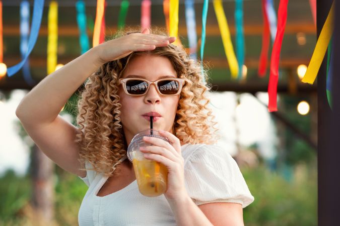 Woman with drink outdoors