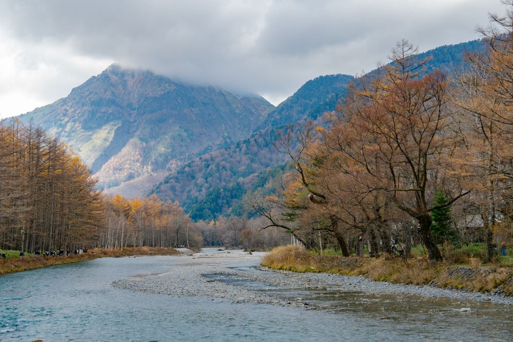 landscape view of japan alps mountain with natural forest, blue river on autumn season at kamikochi Nagano.