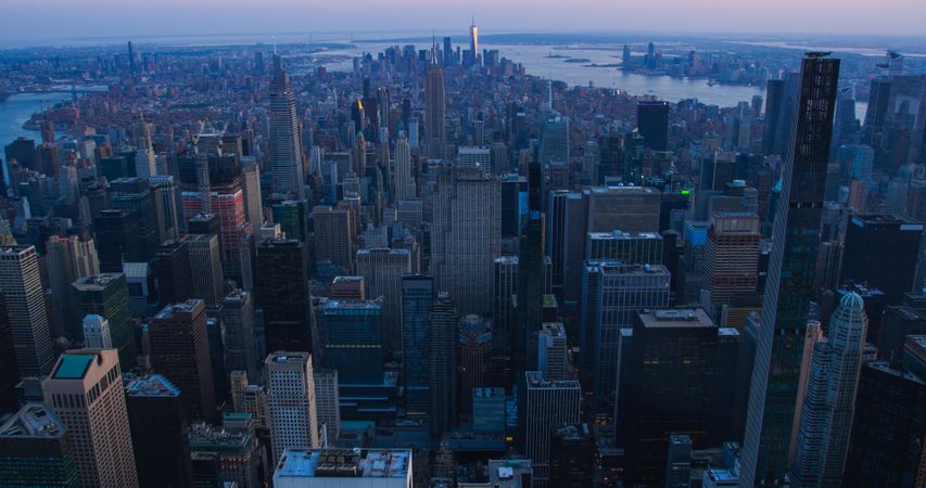 Scenic Aerial New York City View of Lower Manhattan Architecture. Panoramic Downtown Photo from a Helicopter During a Sunset. Cityscape with Modern Office Buildings and Historic Skyscrapers