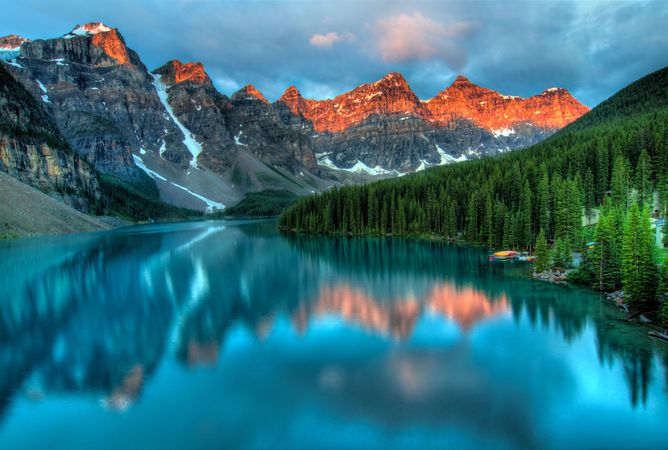 Lake near mountain range under blue sky in Alberta, Canada