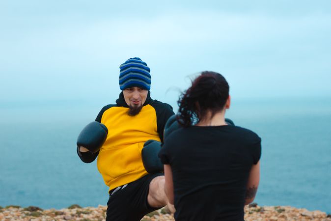 Boxers exercising on cliff
