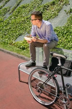 Young business man eating at lunch break outdoors