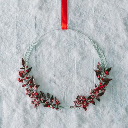 Wooden table background with snow and mistletoe decorations
