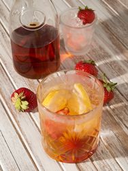 Glass of refreshing strawberry drink in daylight