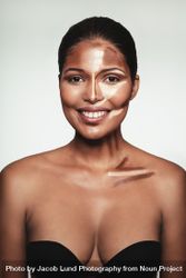 Smiling woman in demo of contouring make up 5w2dm0