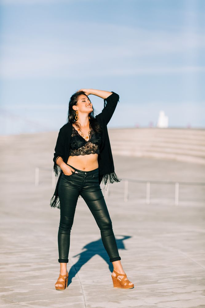 Trendy female standing on urban background