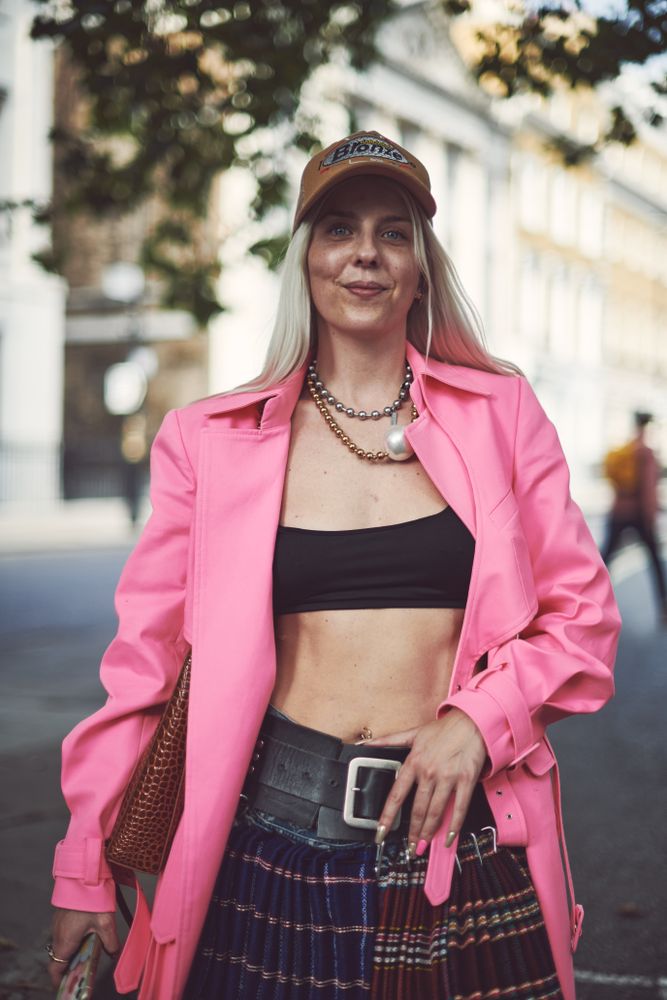 London, England, United Kingdom - September 18 2021: Smiling blonde woman in cap and mini skirt