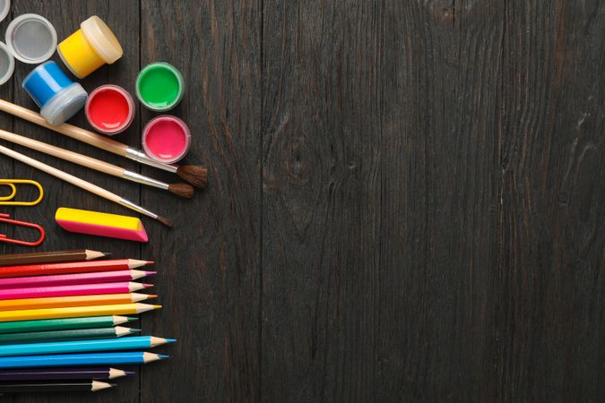 Flat lay composition with school supplies on wooden background, space for text