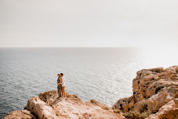 Couple embracing on rock