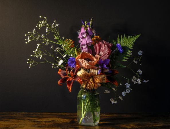 Beautiful full bouquet in vase in dark room