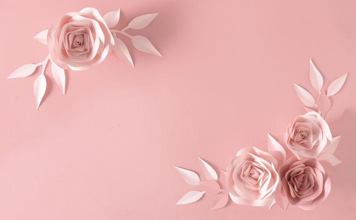 Paper rose flower, leaves and petals on pink background