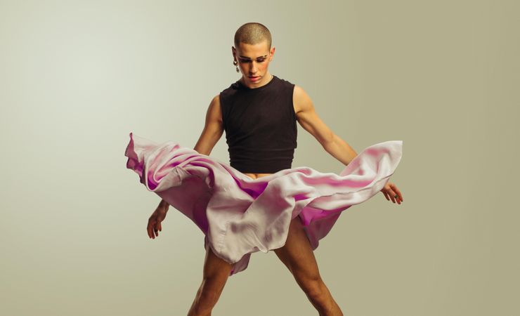 Gender fluid male with skirt flowing in air
