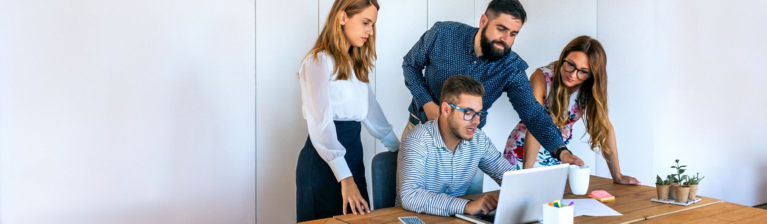 Business people in a meeting standing to review a project