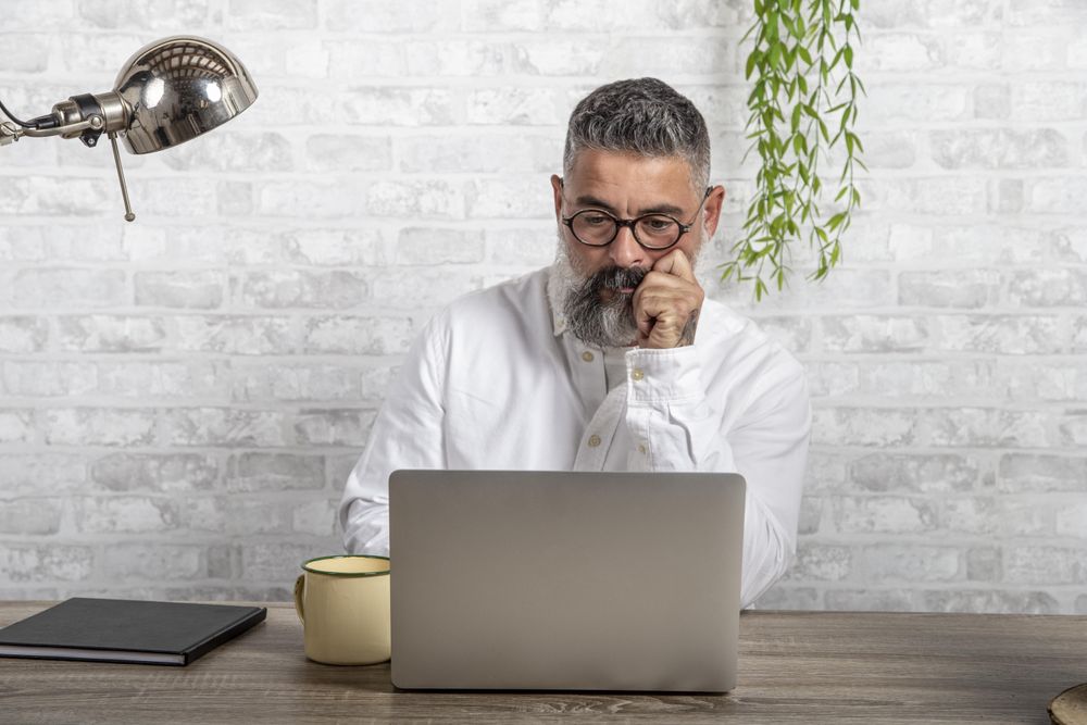 Serious man sitting in front of computer