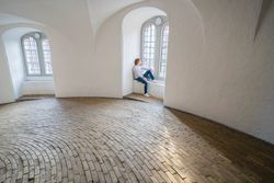 Relaxed woman resting in window sill