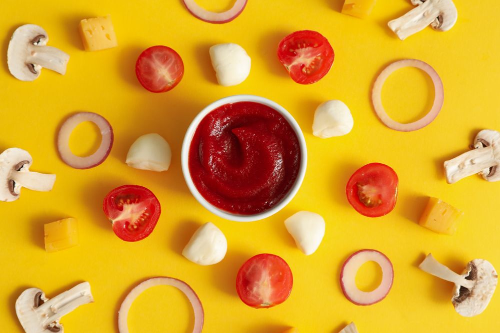 Ingredients for cooking pizza on yellow background