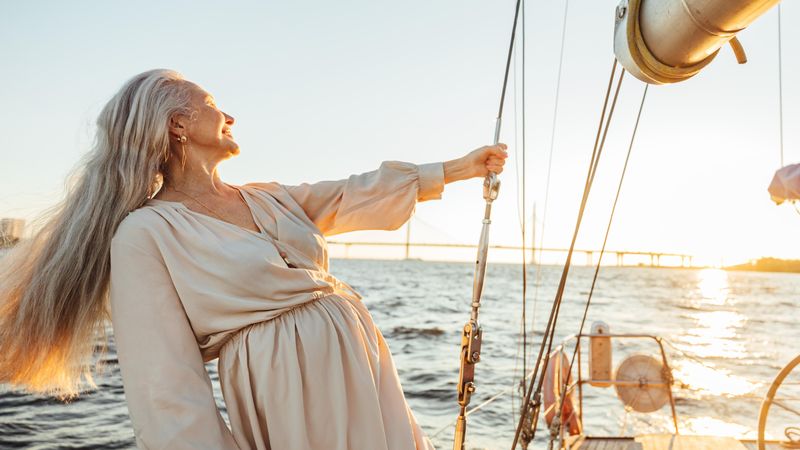 Content older woman on a sailboat