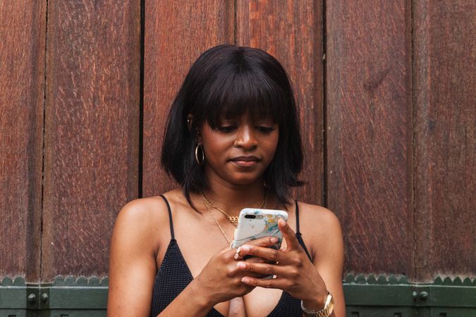Black woman chatting on smartphone