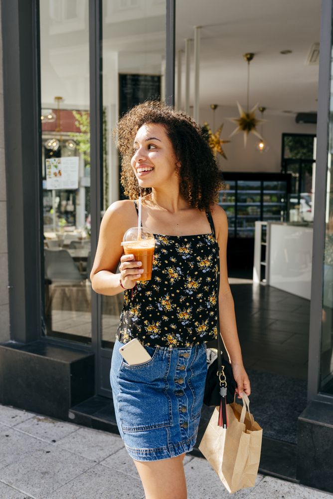 Cheerful woman leaving restaurant