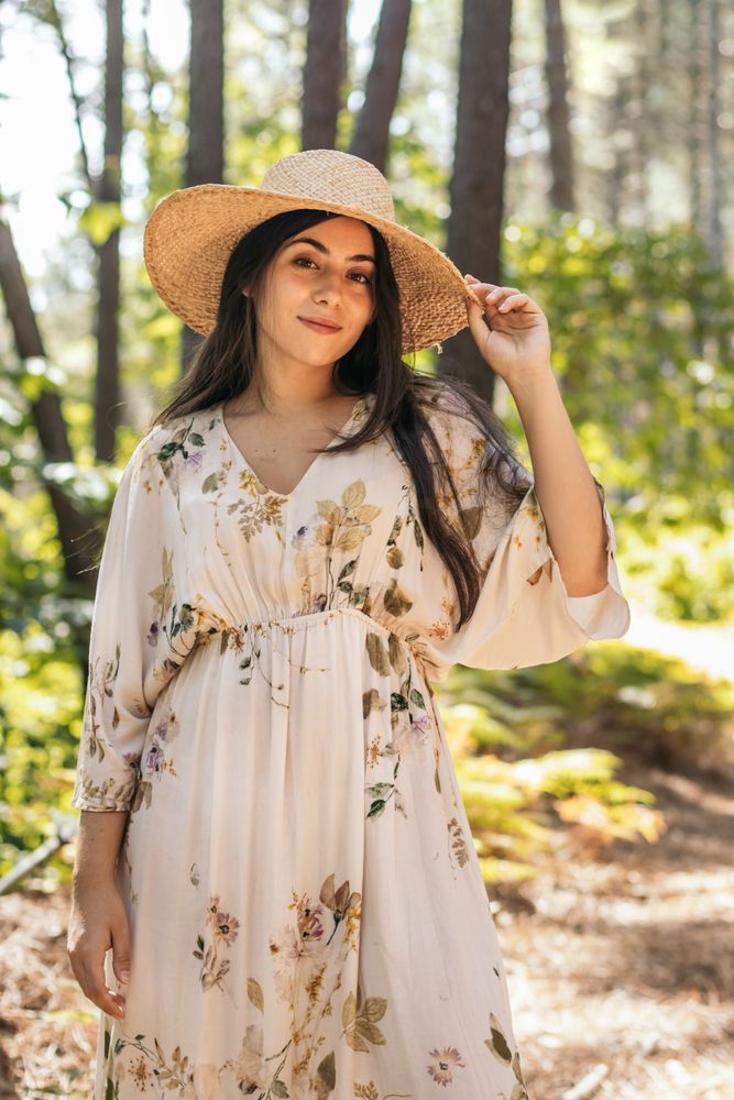 Woman with a straw hat in the forest
