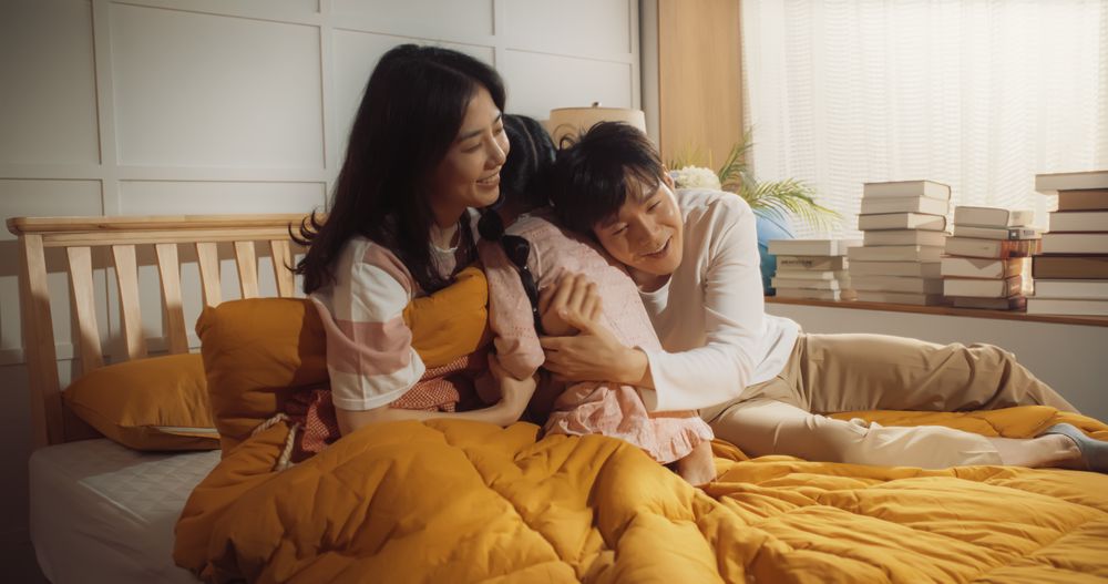 Active and Playful Child Waking Her Parents Up to Face a New Day. Korean Family Getting Ready for a Happy Day,