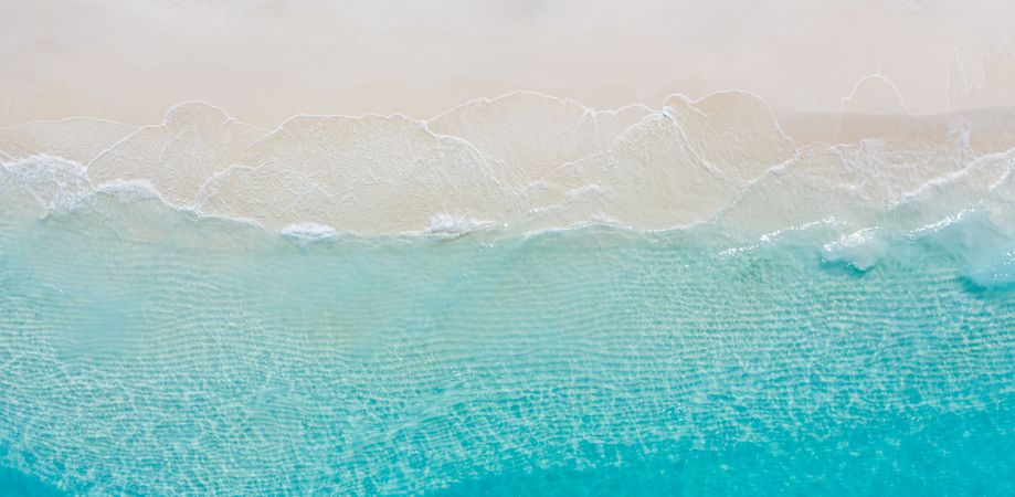 Aerial shot of clear blue water at a tropical beach, wide angle