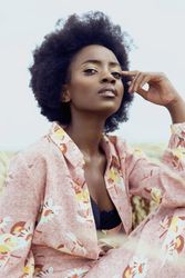Portrait of woman in pink floral robe under blue sky