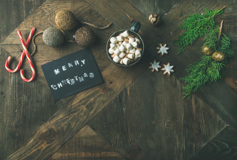 Homely holiday with “Merry Christmas” card, hot chocolate, copy space