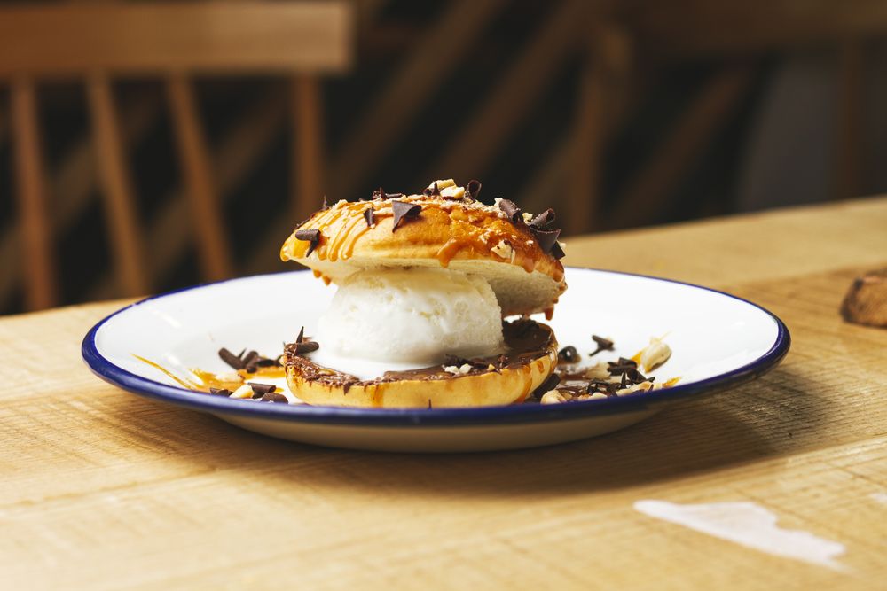 Tasty sweet burger with chocolate crumb and nuts