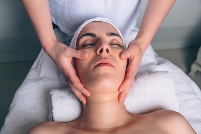 Woman receiving a relaxing facial treatment