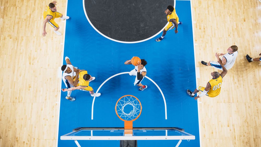 Top Down View of a Talented Basketball Player Jumping To Score Striking Slam Dunk Goal.