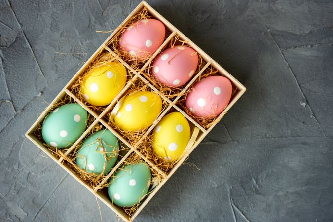 Top view of pastel decorative eggs in box