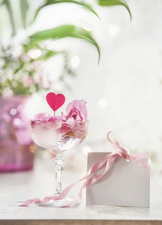 Champagne glass with pink rose petals