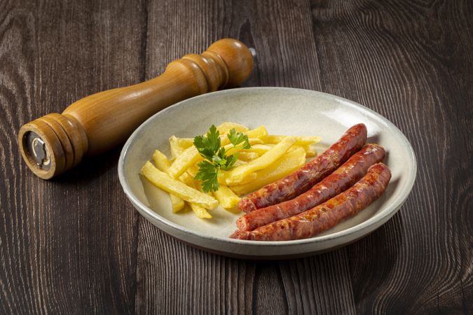 Grilled German sausage with french fries.