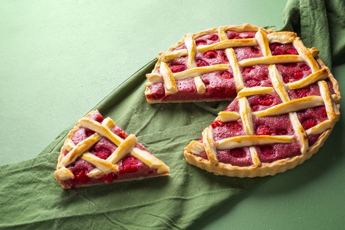 Raspberry pie with a lattice crust. One slice of raspberry tart