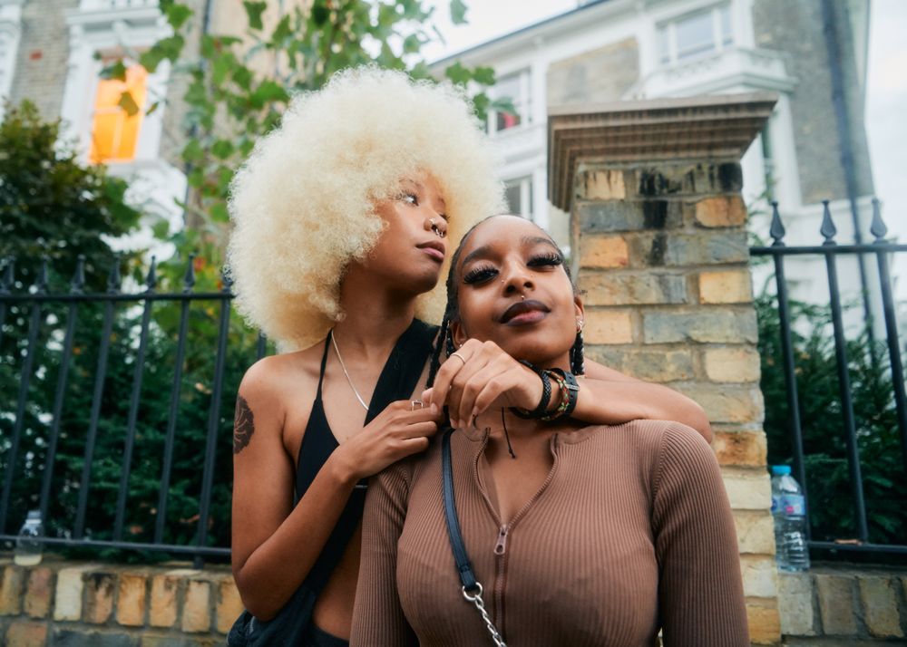 London, England, United Kingdom - August 28, 2022: Female friends hanging out on street