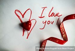 Valentine Day holiday concept with "I love you" written on paper with ribbon and heart ornament 5oDDEg
