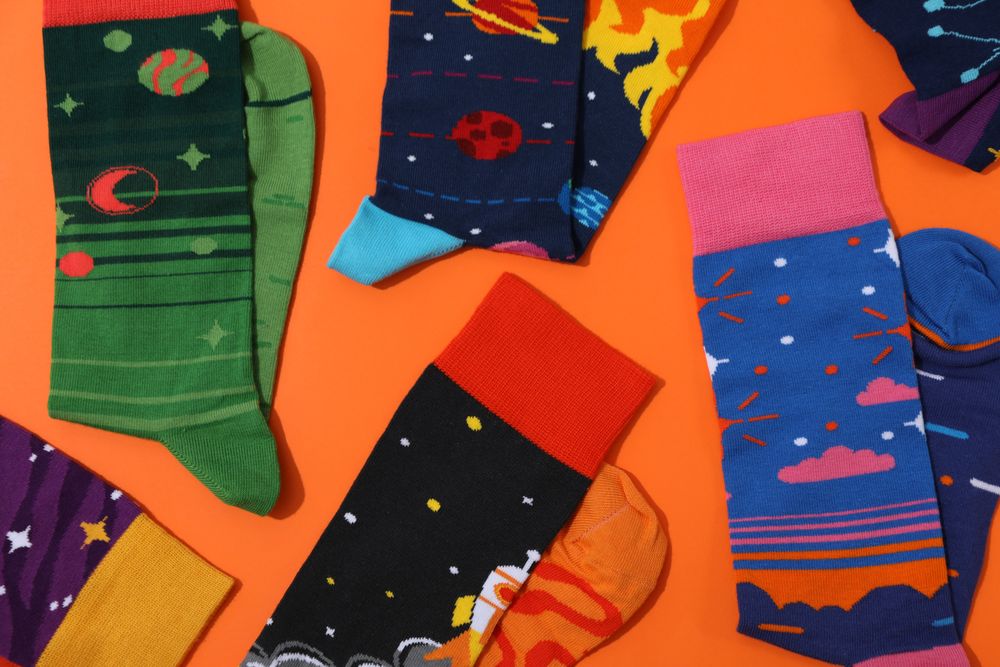 Casual clothes and wearing concept - socks, clothes for foot