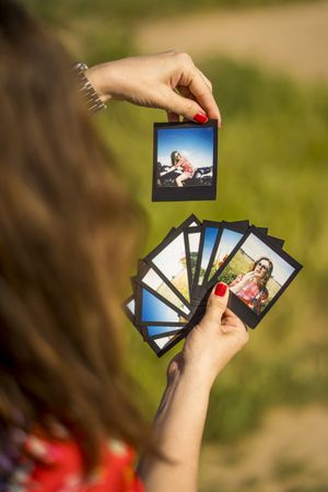 Young woman showing summer photos