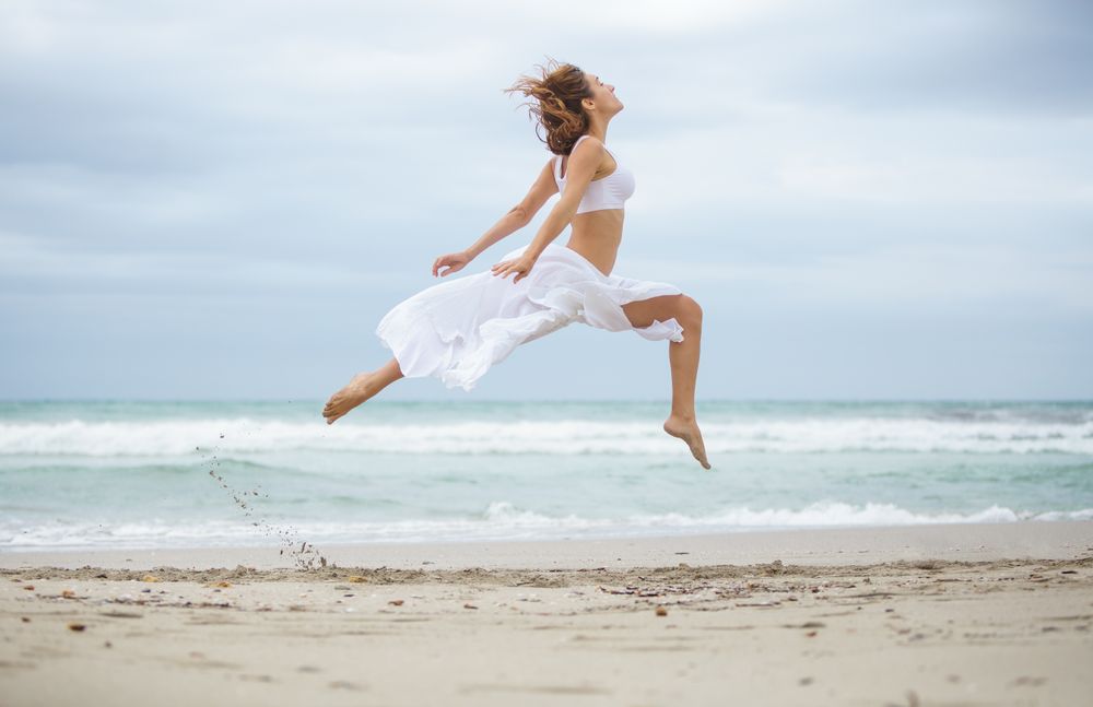 woman dancing near sea