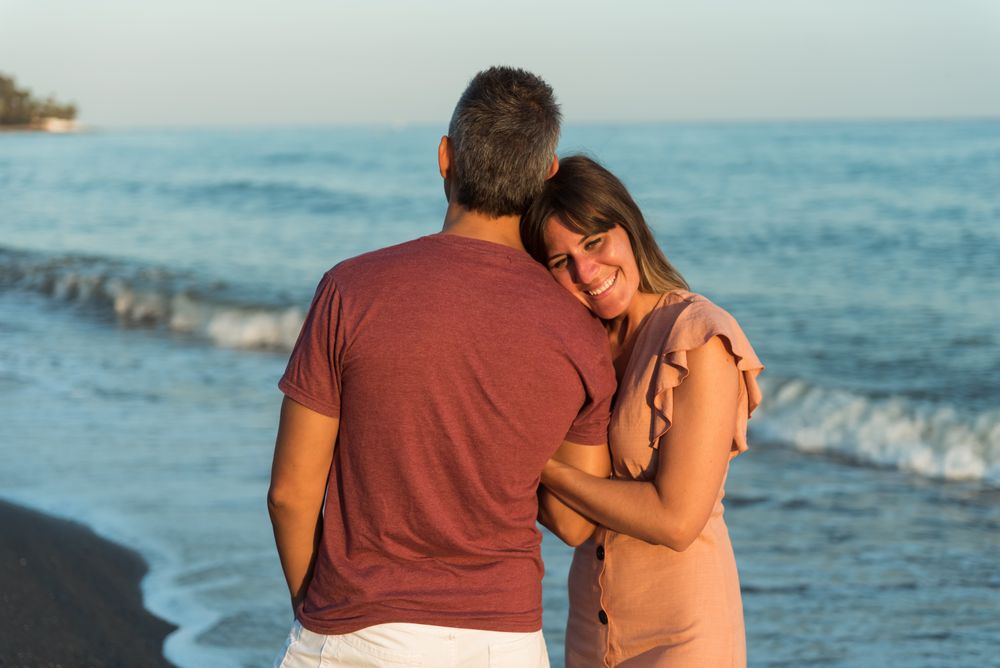 Adult couple embracing near sea