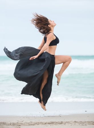 woman dancing near sea