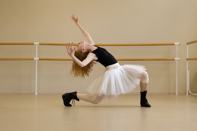 Ballerina bending backward in expressive modern dance move.
