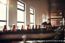 Young man working at alcohol manufacturing factory 4Zdk10
