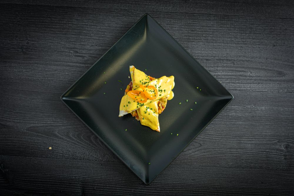 Corvina with yellow pepper sauce in plate